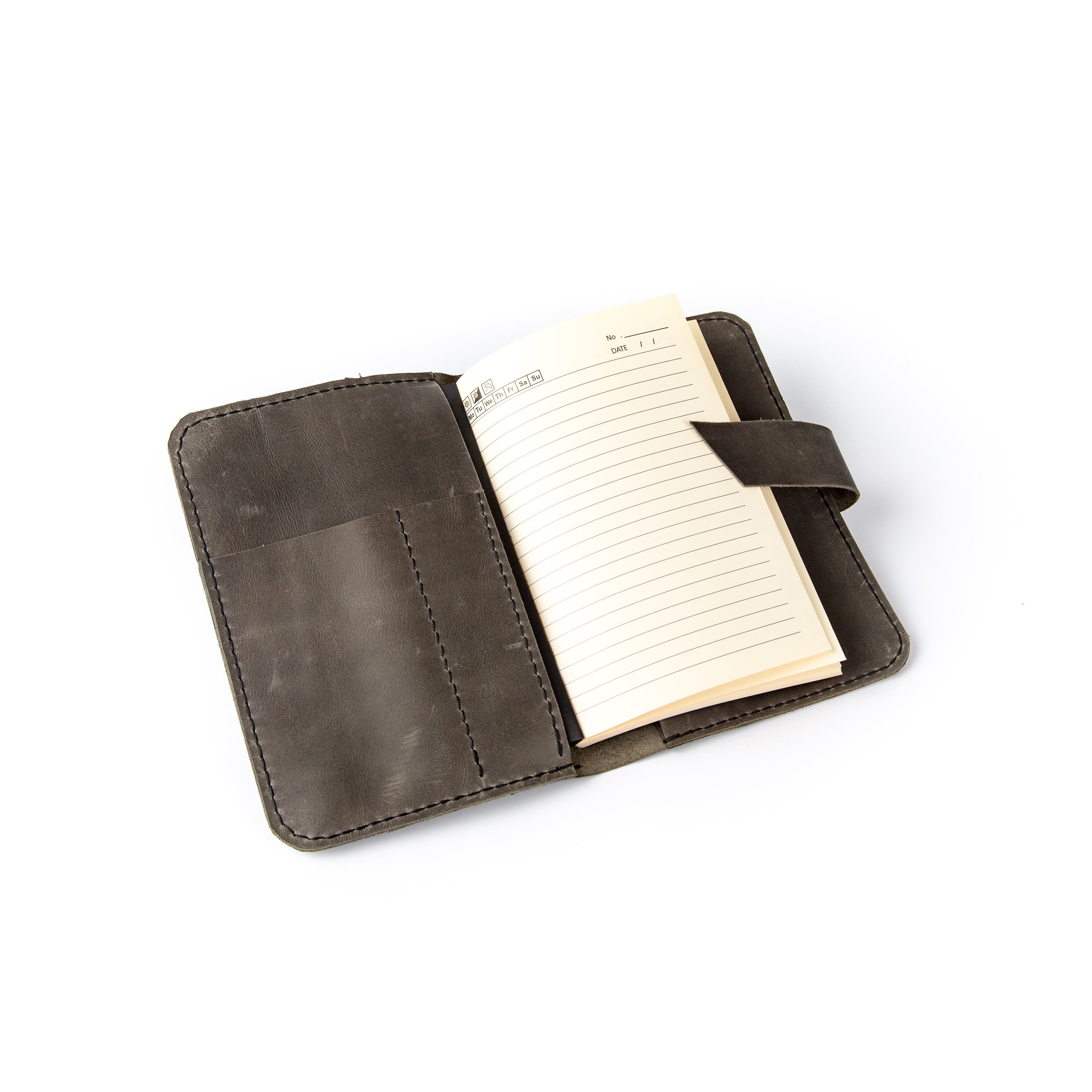 Open dark brown leather journal cover with a lined notebook inside on a white background.