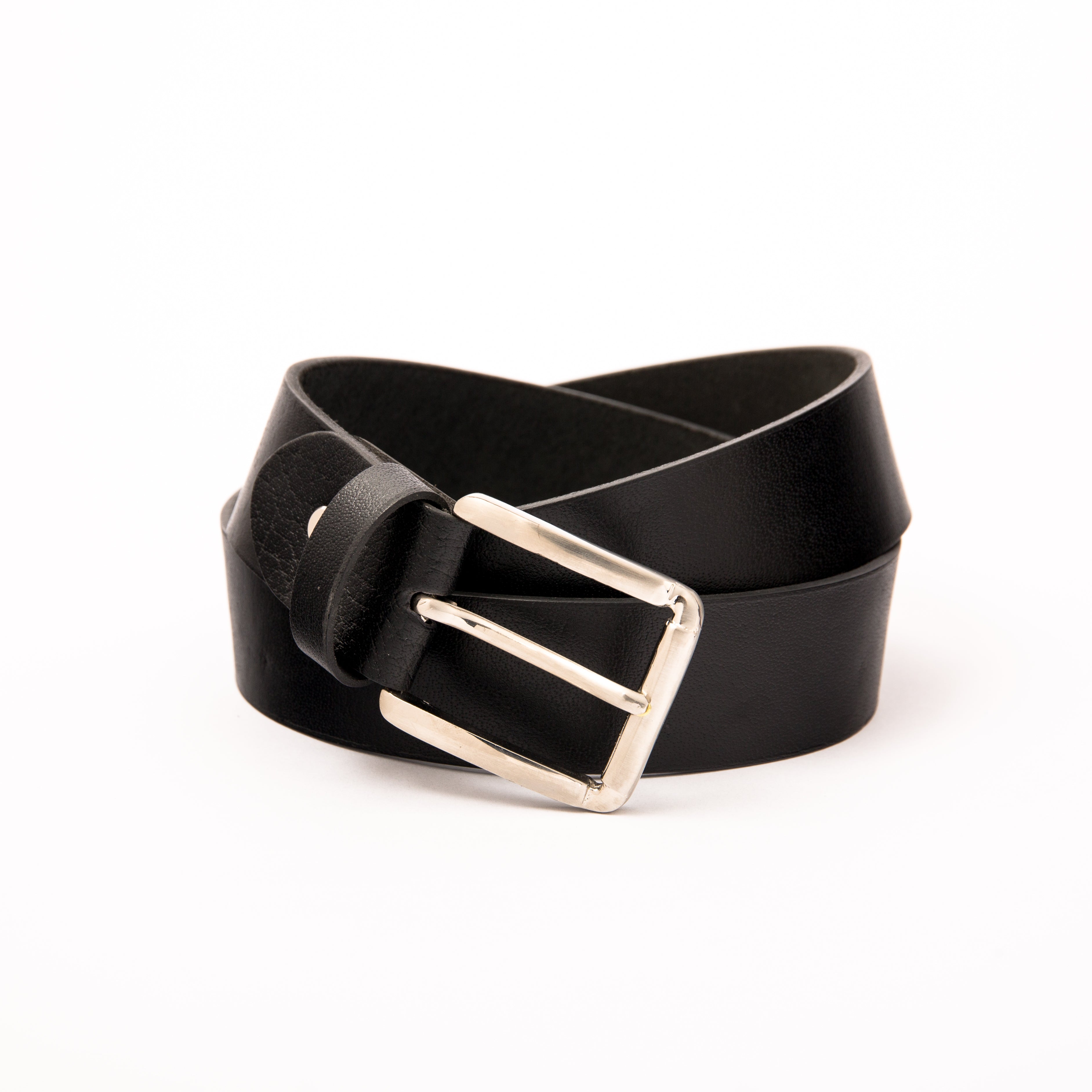 Photo of a casual black leather belt with a polished silver buckle, shown rolled on a clean white background, highlighting the premium natural leather texture and the sleek silver hardware.

