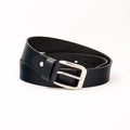 Photo of a casual navy blue leather belt with a polished silver buckle, shown rolled on a clean white background, highlighting the premium natural leather texture and the sleek silver hardware.