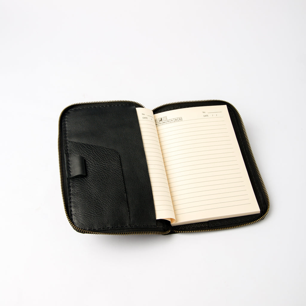 Open view of black refillable leather journal cover with zipper and card slots - Lionell.