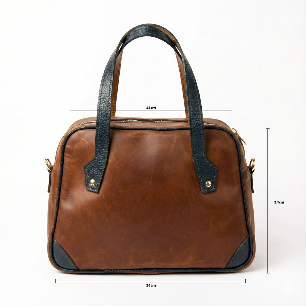 Front view of Lionell "Cairo Muse" leather handbag showing dimensions: 28cm top width, 34cm bottom width, and 24cm height.