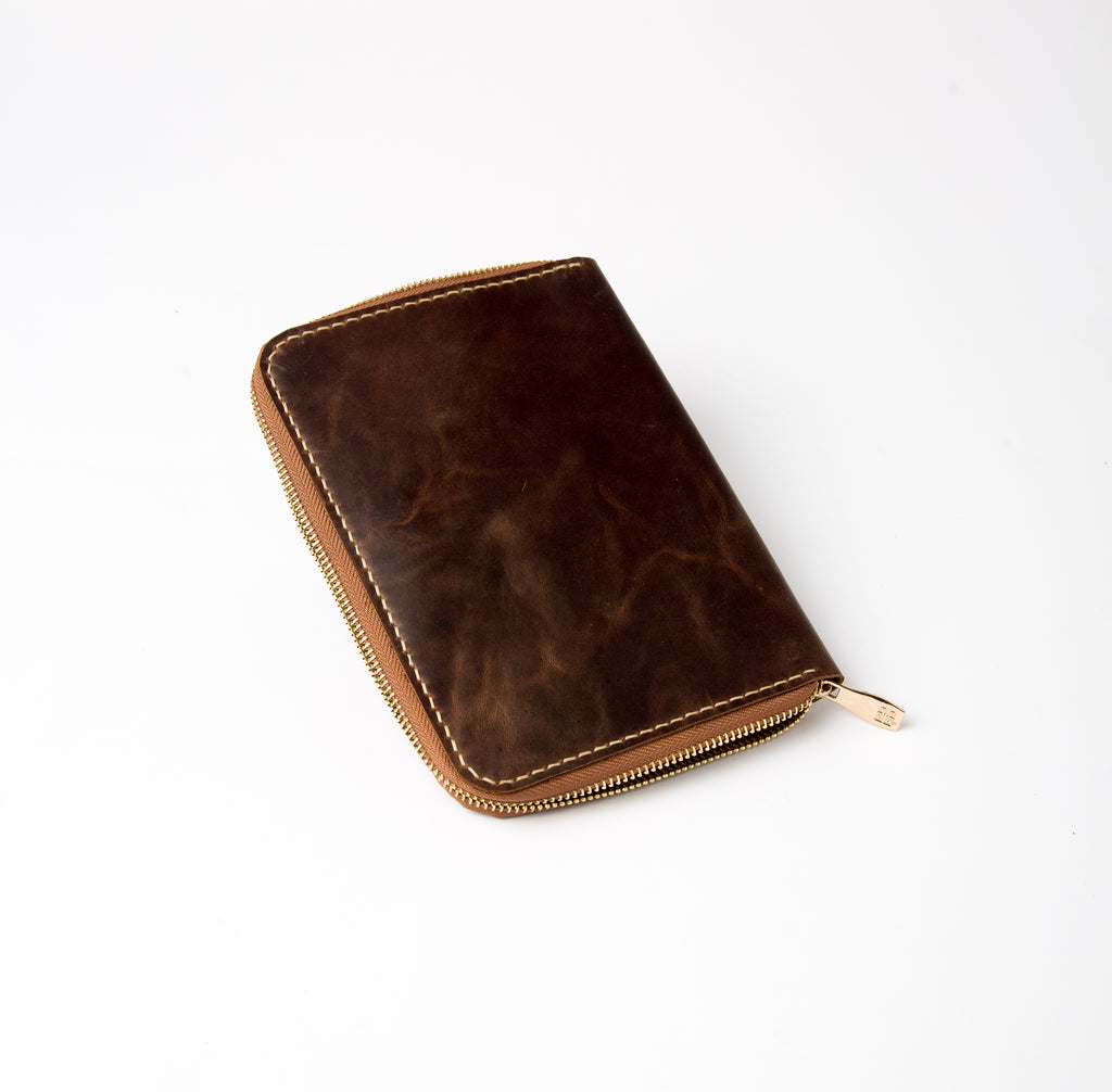 Lionell fully zippered notebook cover in dark brown leather. Handmade secure design.