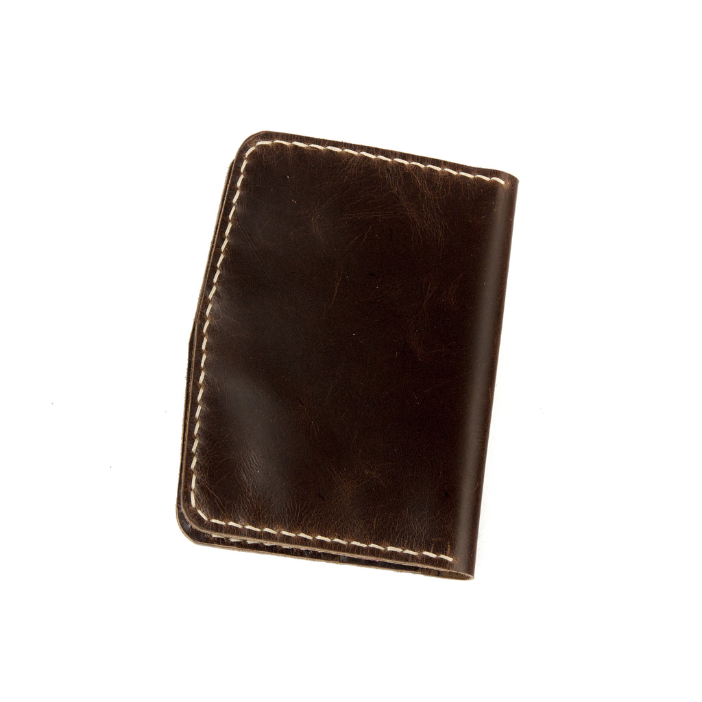 Closed view of Lionell handmade vintage leather passport holder in espresso