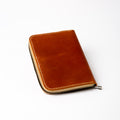 Lionell fully zippered leather notebook cover closed. Vintage tan leather with durable handmade stitching.
