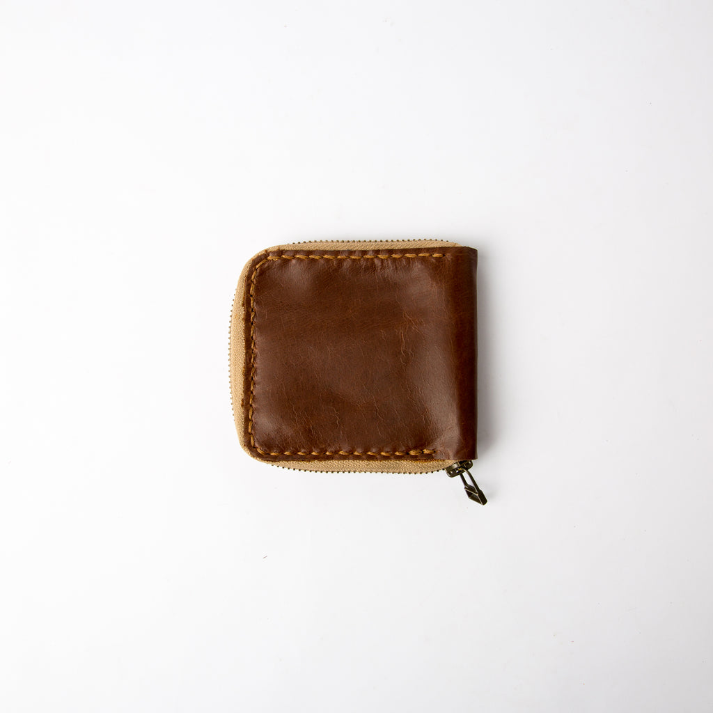 Closed view of Secure zip-around handmade leather chestnut wallet- Lionell.