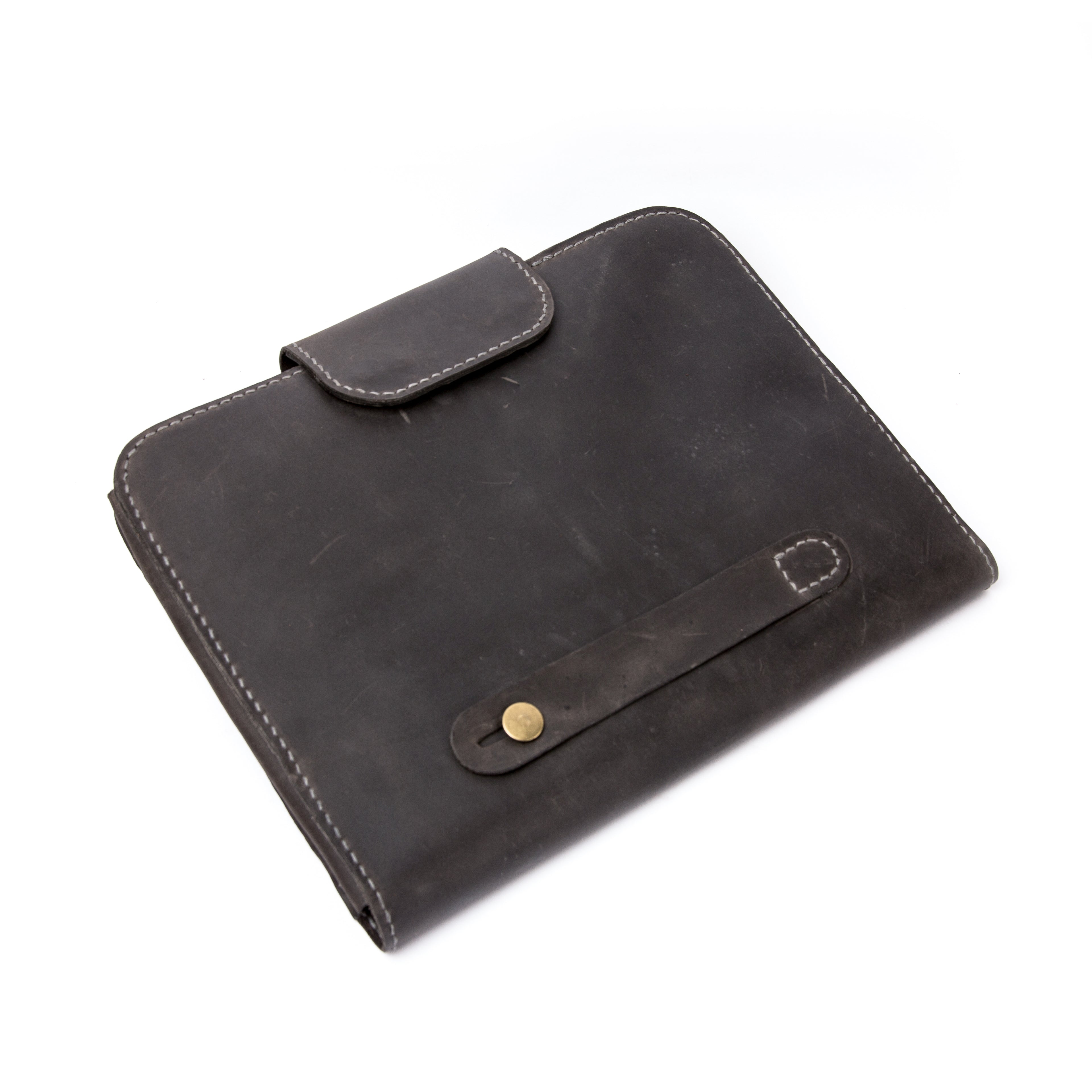 Back view of Lionell leather laptop case showing secure hand strap and brass button closure.
