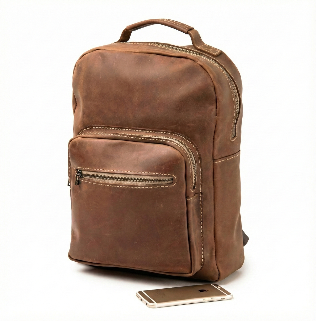 Front view of Lionell "The Heritage Pack" handmade leather backpack with zipper pockets and vintage finish.