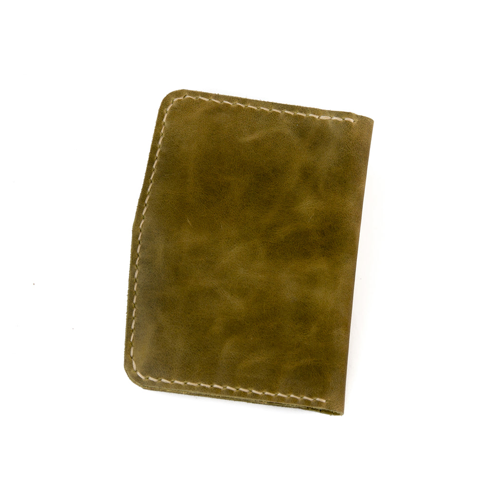 Closed view of Lionell handmade vintage leather passport holder in olive
