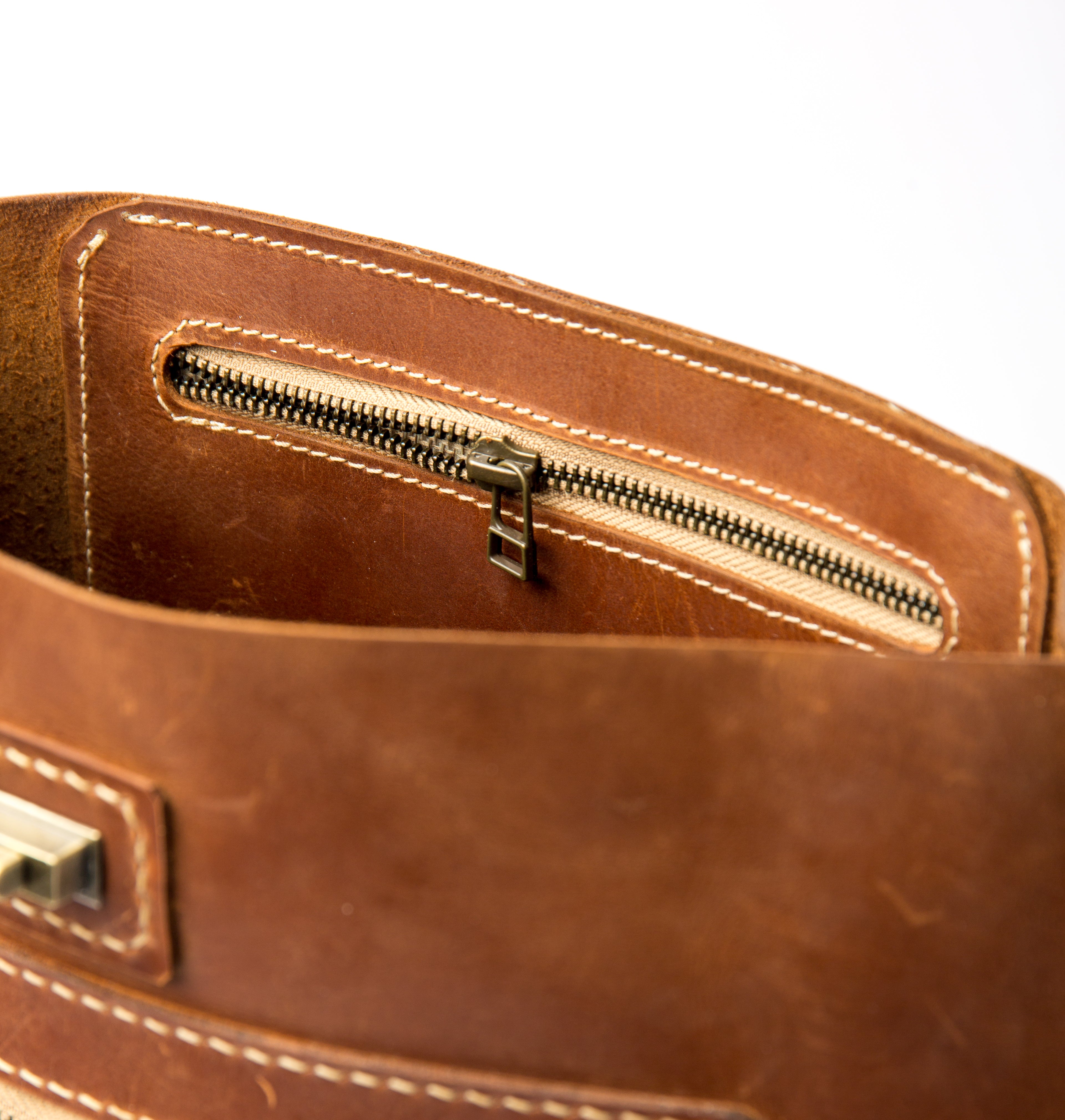 Close-up of interior zippered security pocket inside Lionell "The Sphinx" handmade leather bag.