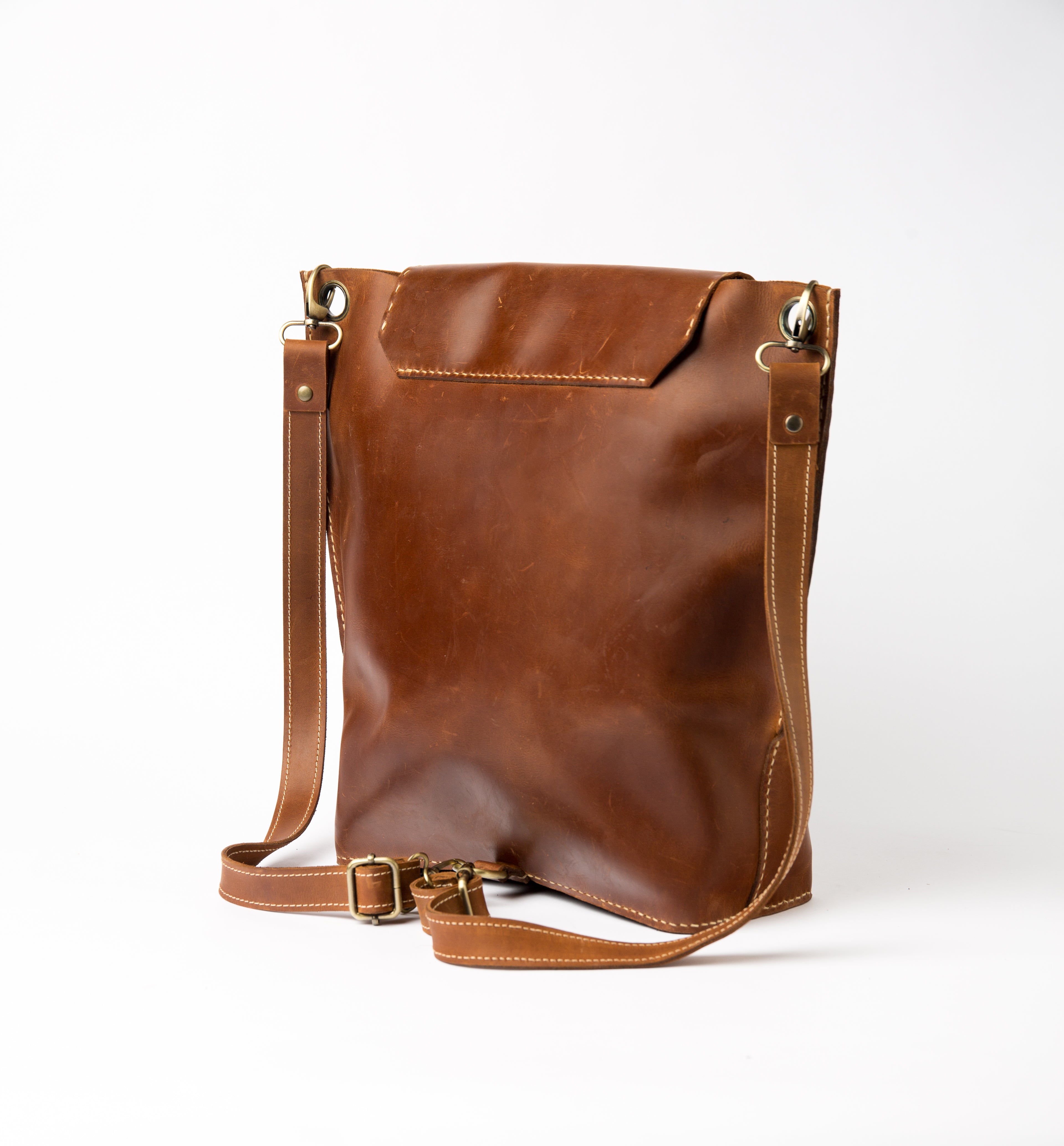 Back view of Lionell "The Sphinx" leather shoulder bag showing adjustable strap and vintage leather finish.