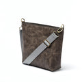 Handmade grey leather Urban Cross Bag with a textured finish and an adjustable grey fabric strap.