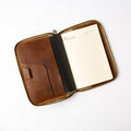 Front view of vintage brown refillable leather journal with zipper and interior pockets - Lionell.