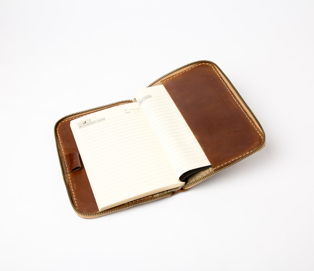 Open view of vintage brown refillable leather journal with zipper and interior pockets - Lionell.