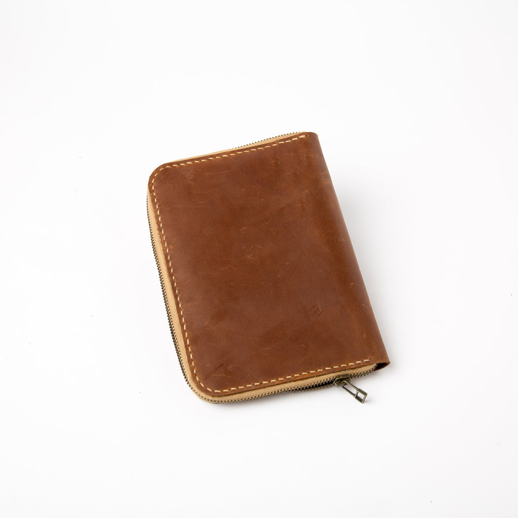 Lionell fully zippered notebook cover in vintage brown leather. Durable handmade design.