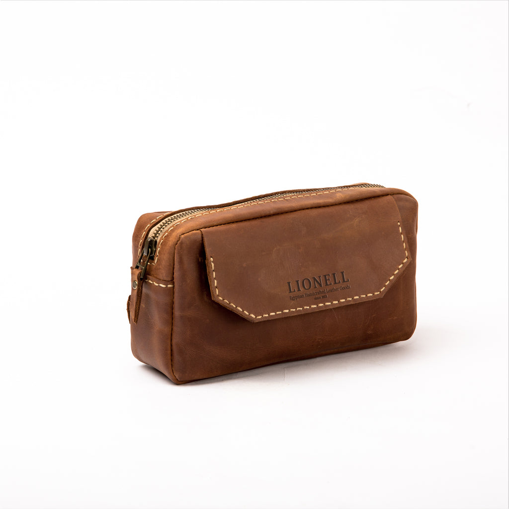 Front view of a LIONELL handcrafted small vintage brown leather handbag, featuring the brand logo on the front flap with visible decorative stitching and a sturdy top zipper.