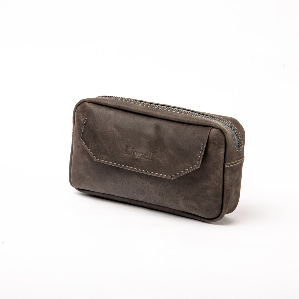 Front view of a LIONELL handcrafted small vintage grey leather handbag, featuring the brand logo on the front flap with visible decorative stitching and a sturdy top zipper.